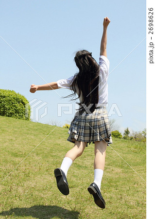中学生 後ろ姿 女の子 ジャンプの写真素材