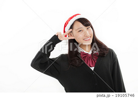 クリスマス 女子高生 高校生 ピースの写真素材