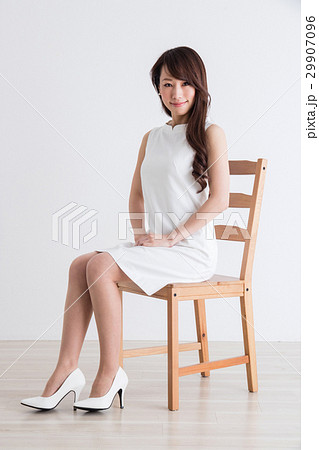 ワンピース 女性 座る ポートレートの写真素材