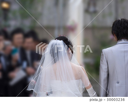 後姿 ウエディングドレス 背中 結婚式 新郎 タキシードの写真素材