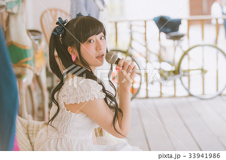 アイドル 女性 歌う マイクの写真素材