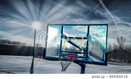 Half basketball courts with view of majestic mountain and overcast