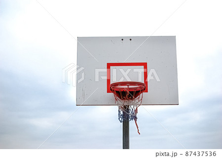 Half basketball courts with view of majestic mountain and overcast