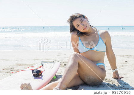 perfectly built Beautiful and young girl with wide hips in a striped orange  swimsuit stands and