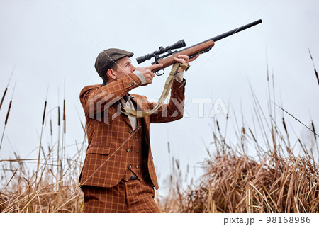 Confident caucasian hunter. American hunting rifles. Hunting
